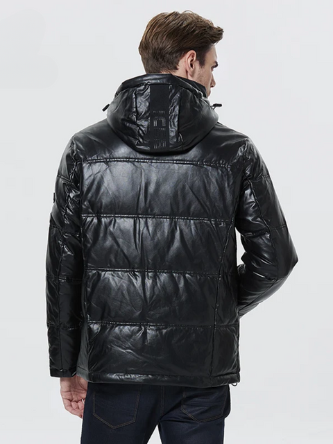 A stylish man wearing a leather jacket with a hood facing away. 
