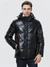 A good looking man wearing a leather jacket with thick padding, a hood, and a zipper closure.