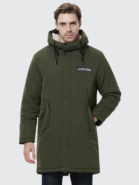 A stylish man wearing a dark blue coat with a thick inner lining, a hood, a zipper closure, and pockets on both sides.